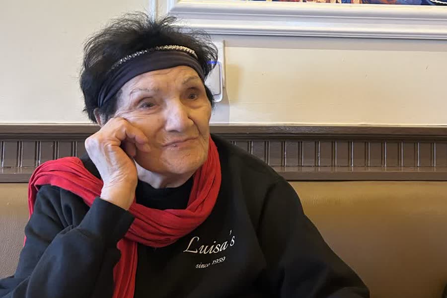 Luisa at a table in the dining room, in her own Luisa's sweatshirt