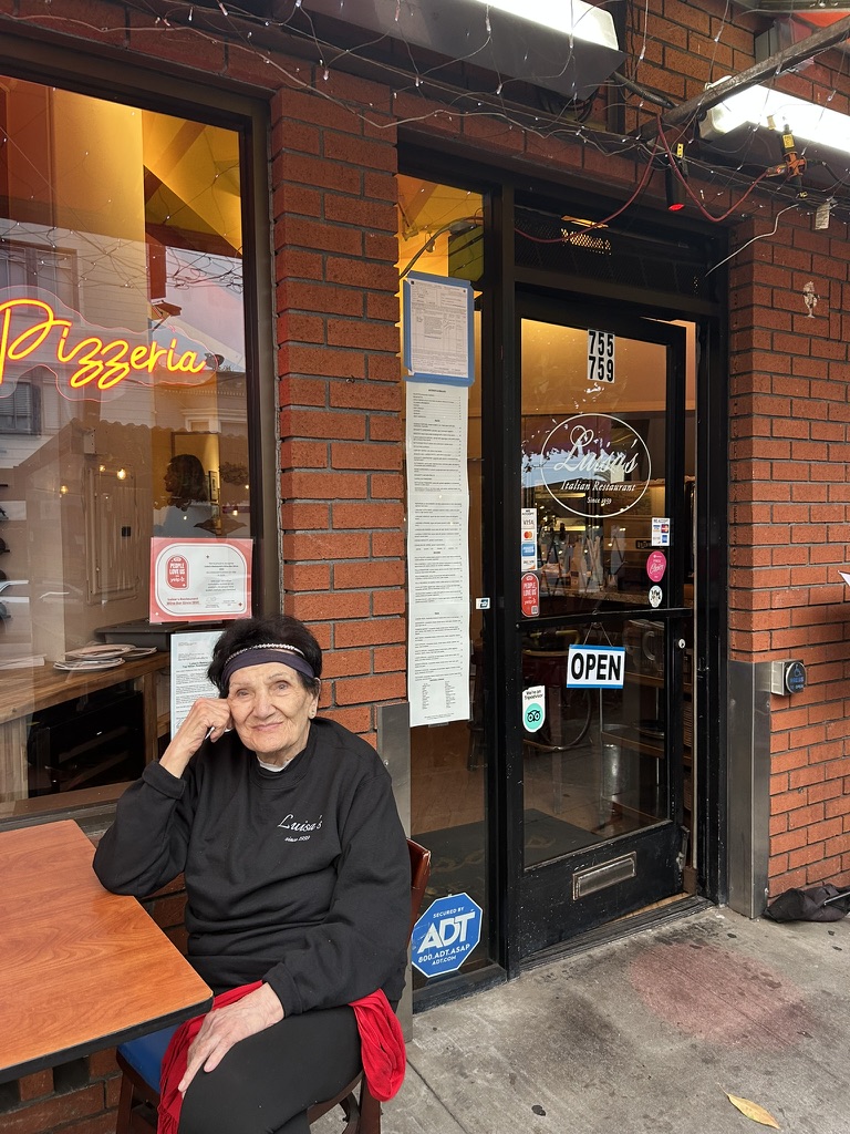 Outside the door at 759 Columbus Avenue in a Luisa's crewneck